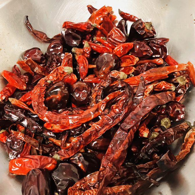 wok full of bright red chili peppers